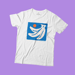 Open image in slideshow, A white t-shirt flat on lilac background. The print on the shirt is an off-white hand of bananas with an orange circle next to them on a blue square background.
