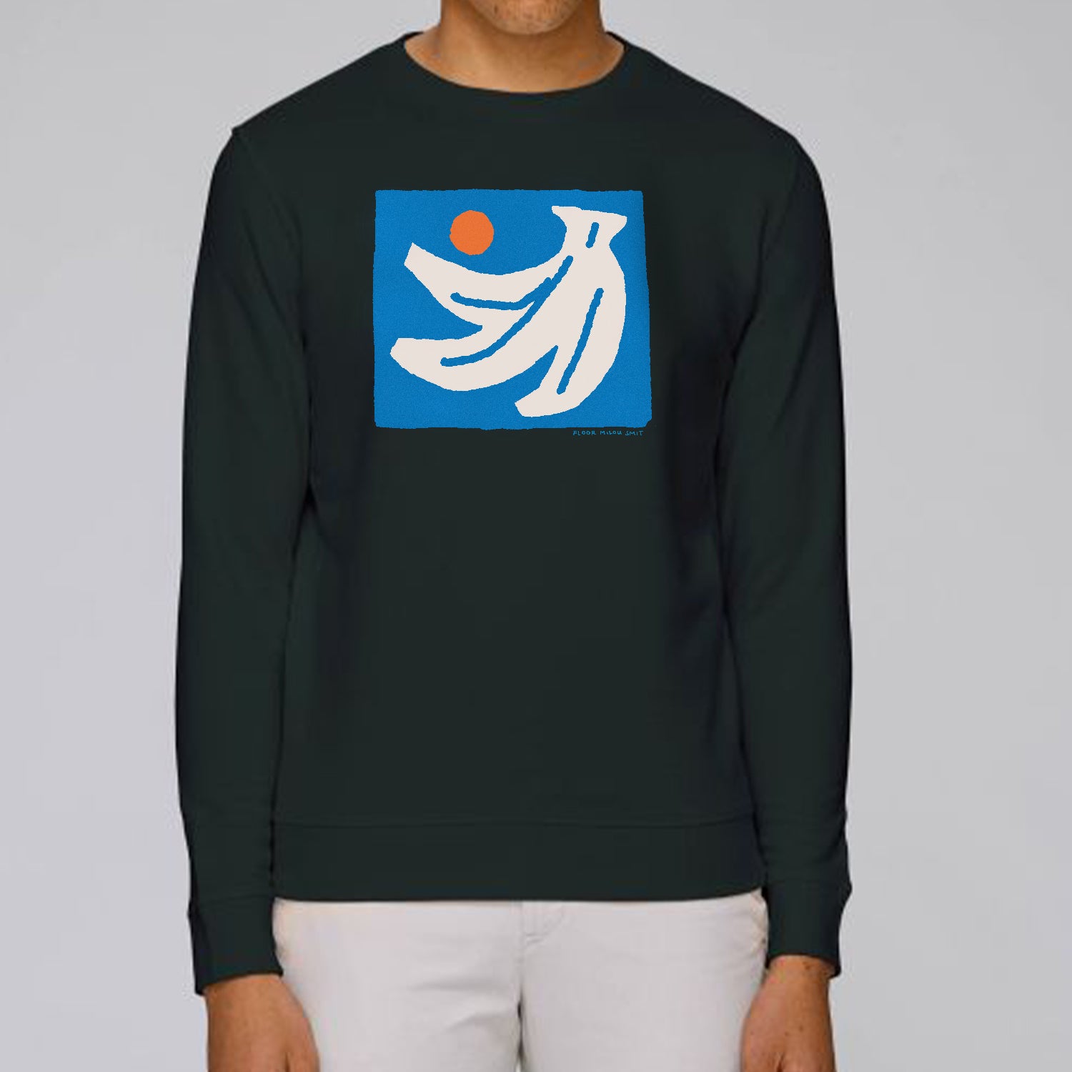 Photo of a model wearing a black sweater. The print on the sweater is an off-white hand of bananas with an orange circle next to them on a blue square background.