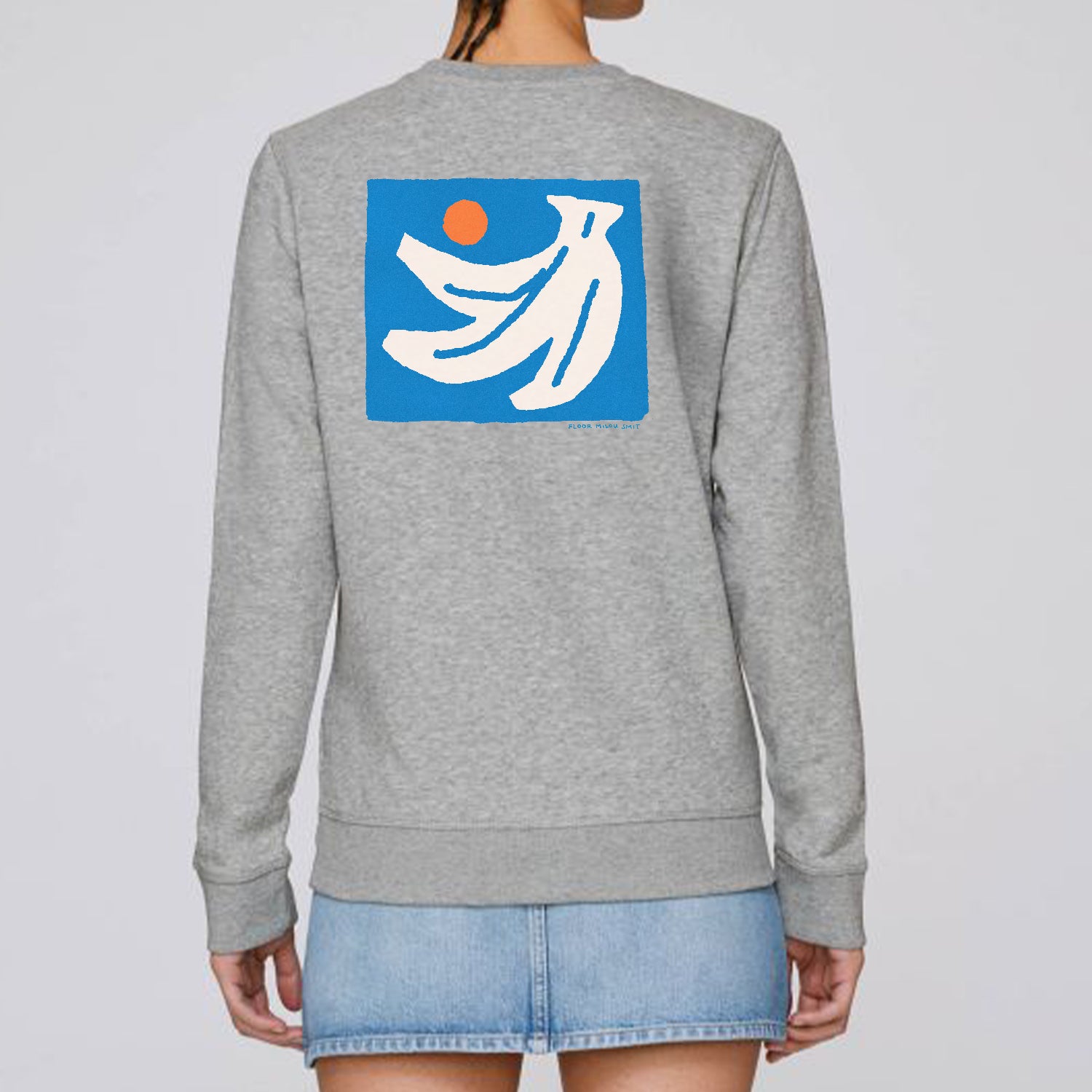 Photo of a model wearing a heather grey sweater. The print on the sweater is an off-white hand of bananas with an orange circle next to them on a blue square background.